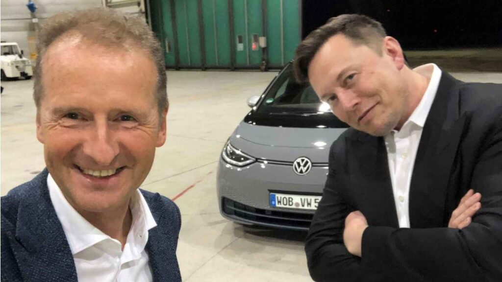 Volkswagen CEO Herbert Diess with Tesla chief Elon Musk in front of a Volkswagen ID.3 electric car