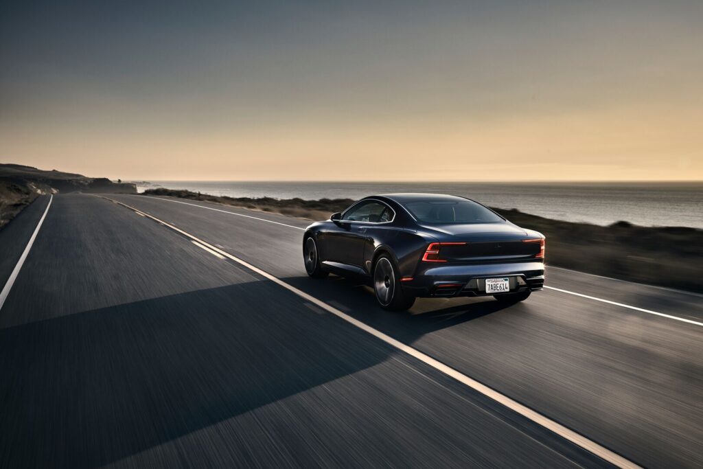 Polestar 1 hybrid car driving on a country road