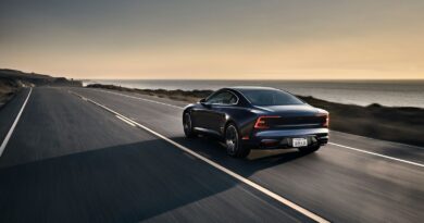 Polestar 1 hybrid car driving on a country road