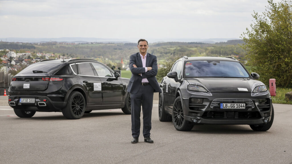 Heavily camouflaged Porsche Macan EV development vehicles with Michael Steiner, Member of the Executive Board, Research and Development, at Porsche