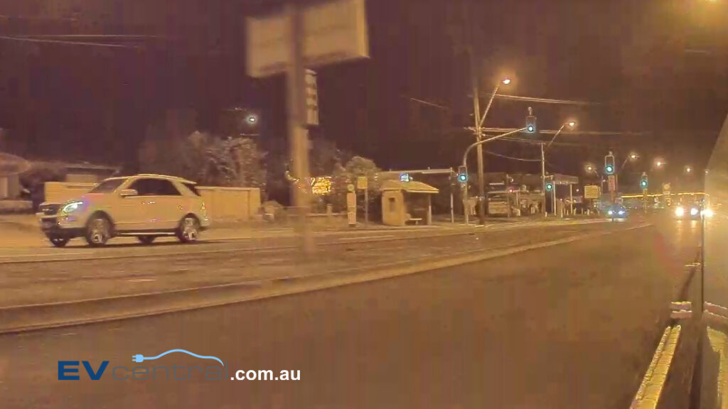 A screen shot from the camera of a Tesla Model 3 showing a car being pursued by police in NSW