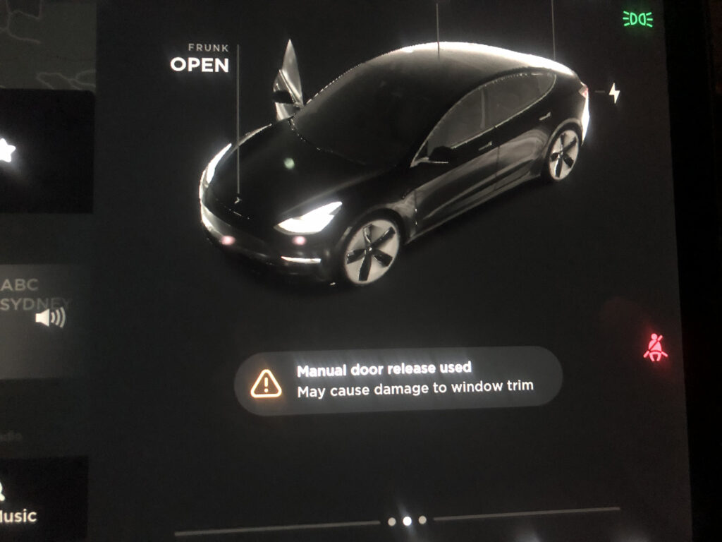 Tesla Model 3 SR+ warning about using the manual door release