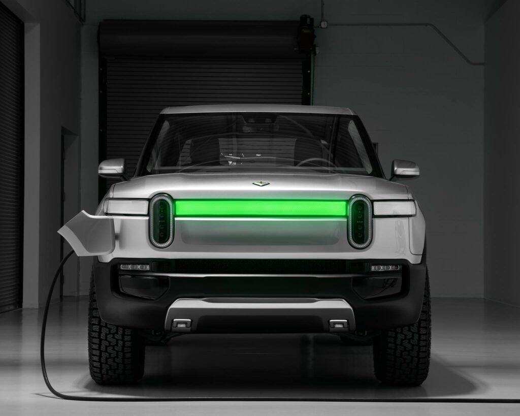 Rivian being recharged with the DRLs showing charging status