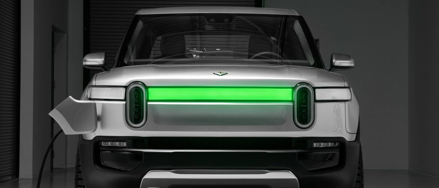 Rivian being recharged with the DRLs showing charging status