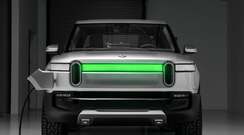 Rivian being recharged with the DRLs showing charging status