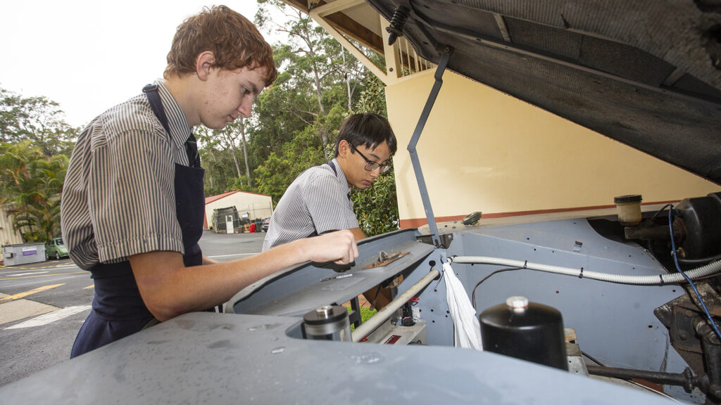 Queensland's Matthew Flinders Anglican College students at work on their Mike King with his 1974 Land Rover Series III with electric conversion