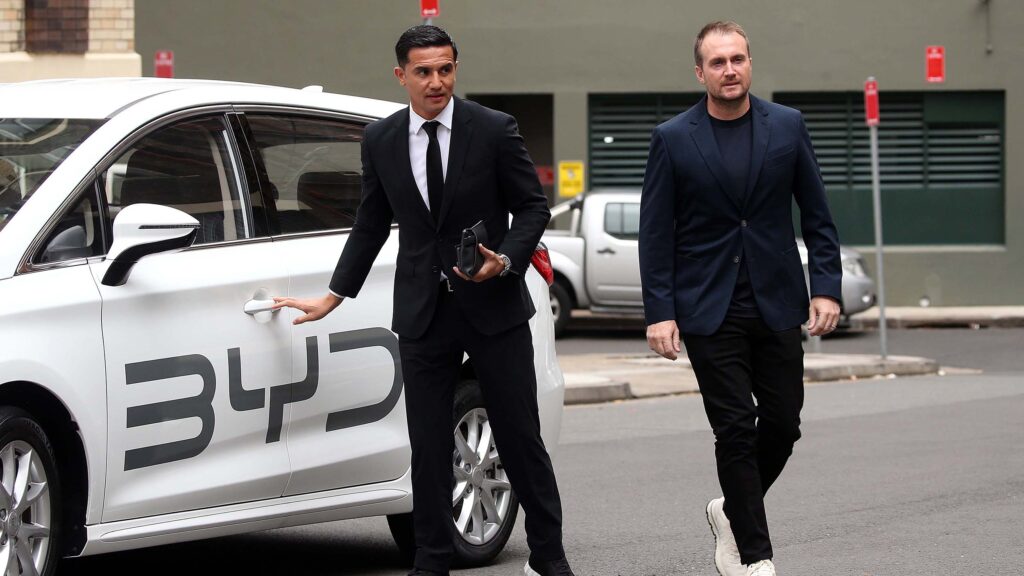 EVdirect CEO Luke Todd with soccer star Tim Cahill arriving at the BYD showroom in Sydney