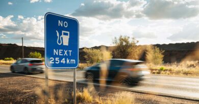 Cupra Born in the outback with a sign warning of no fuel for 254km