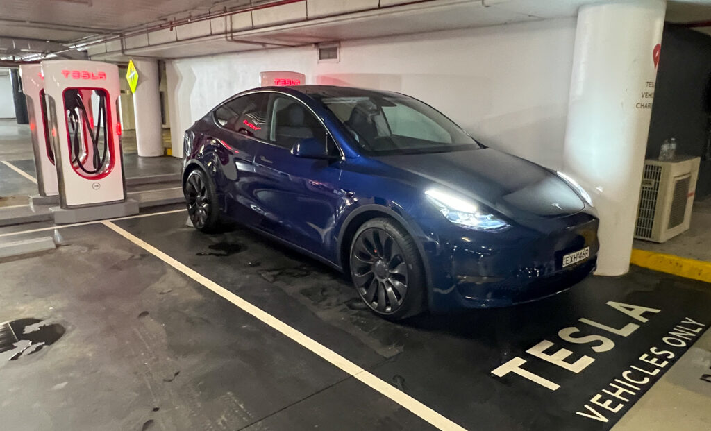 Tesla Model Y Performance being charged at a Tesla Supercharger