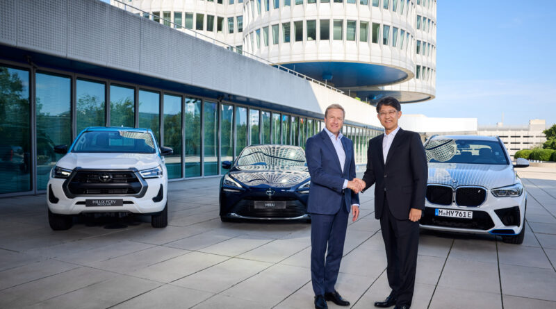 Toyota president Koji Sato and BMW chairman Oliver Zipse at BMW’s headquarters in Munich to announce an increased collaboration on the development of fuel cell electric vehicle technology. Behind them is a Toyota Hilux FCEV prototype, Toyota Mirai and BMW iX5 FCEV development vehicle.