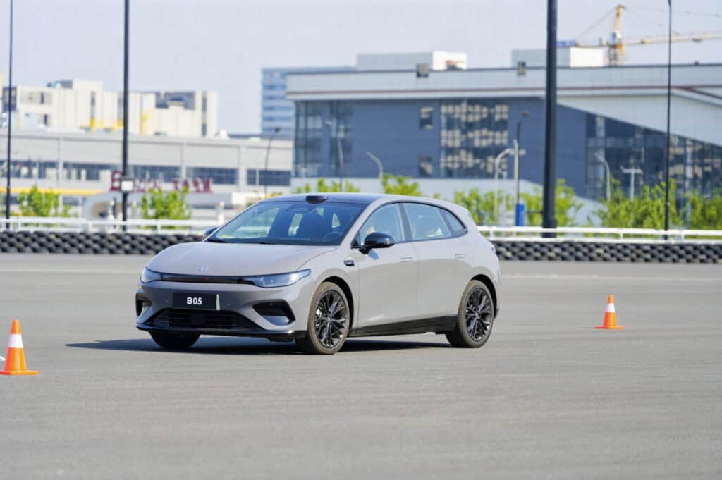 White Leapmotor B05 hot hatch testing on a closed track with traffic cones.